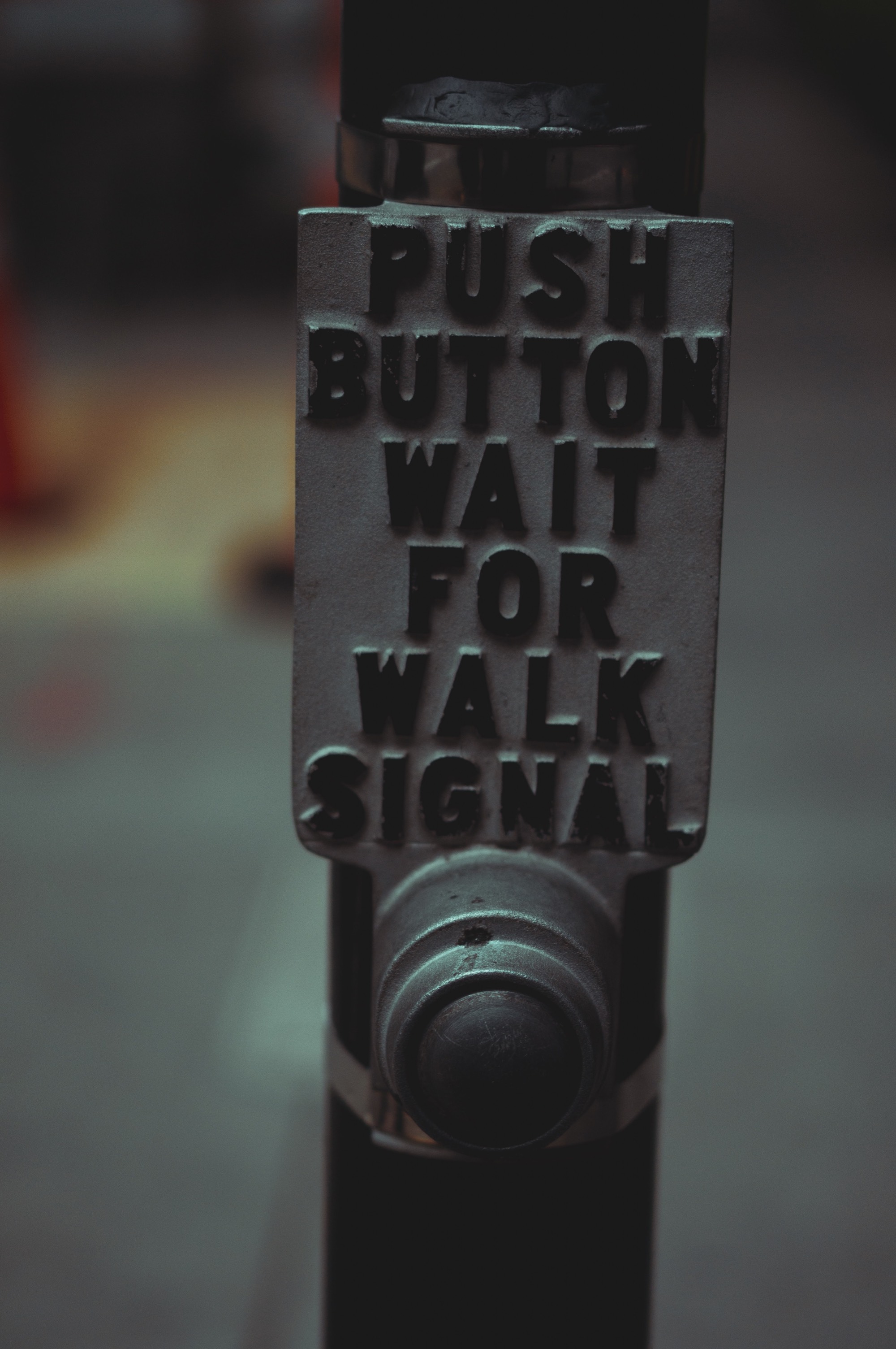 photograph of a crosswalk button sign